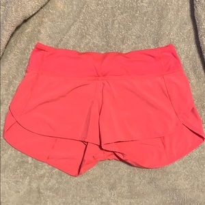 Neon pink shorts with a zipper in the back